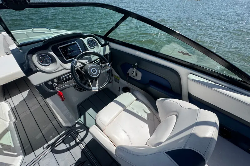 Slide: The Image of 2020 Chaparral Vortex 223 VRX boat cockpit with steering wheel and dashboard controls. - 14