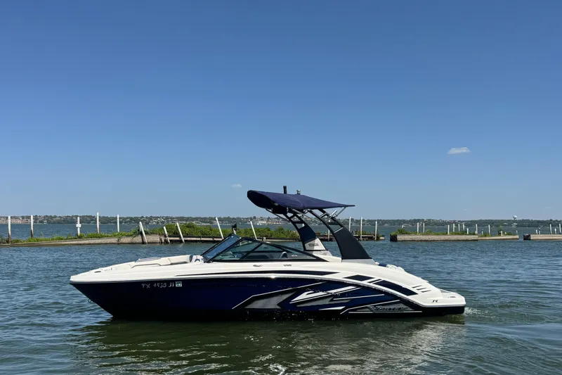 The Image of 2020 Chaparral Vortex 223 VRX boat on calm water under clear blue sky. - 1