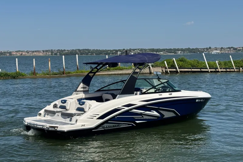 Slide: The Image of 2020 Chaparral Vortex 223 VRX boat on a sunny lake, featuring sleek design and blue accents. - 6
