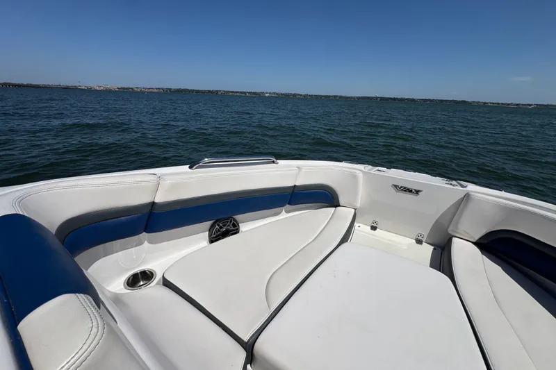 Slide: The Image of 2020 Chaparral Vortex 223 VRX boat interior with blue and white seating on open water. - 10