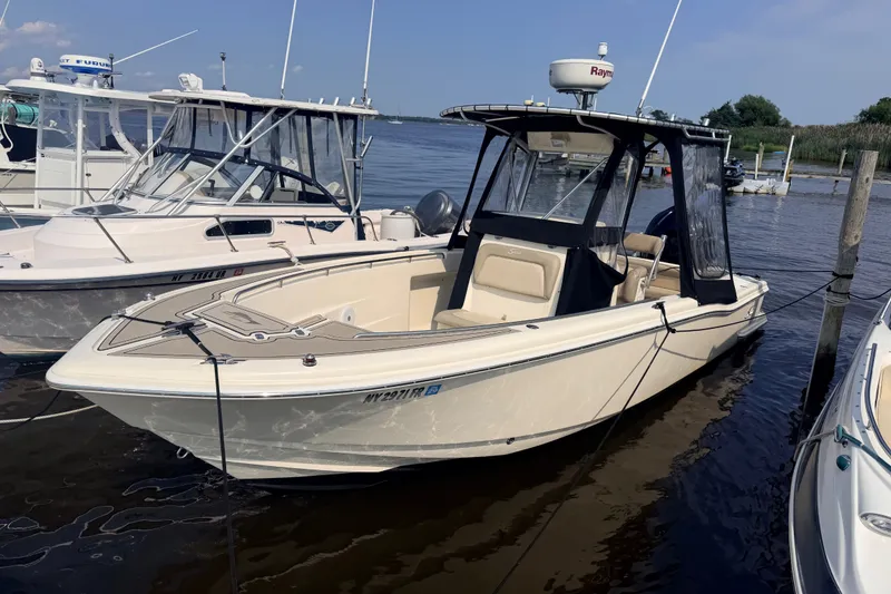 Slide: The Image of 2005 Scout 235 Sportfish in a marina, featuring a hardtop and Raymarine radar. - 20