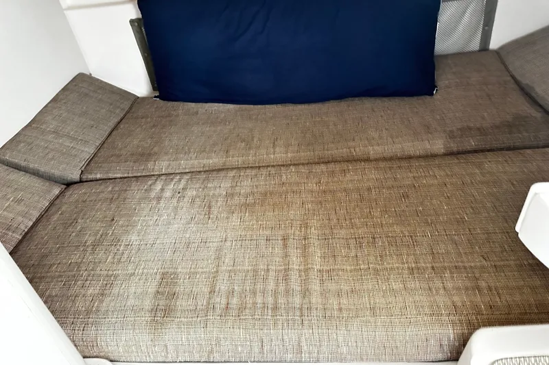 Slide: The Image of 2007 Grady-White Express 305 cabin interior with beige upholstery and blue cushion. - 17