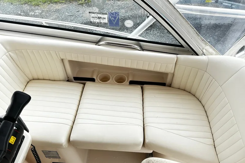 Slide: The Image of 2007 Grady-White Express 305 boat interior with white cushioned seating and cup holders. - 13