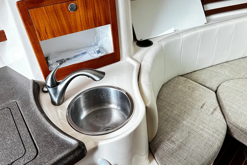 Slide: The Image of 2007 Grady-White Express 305 boat interior with sink and seating area. - 19