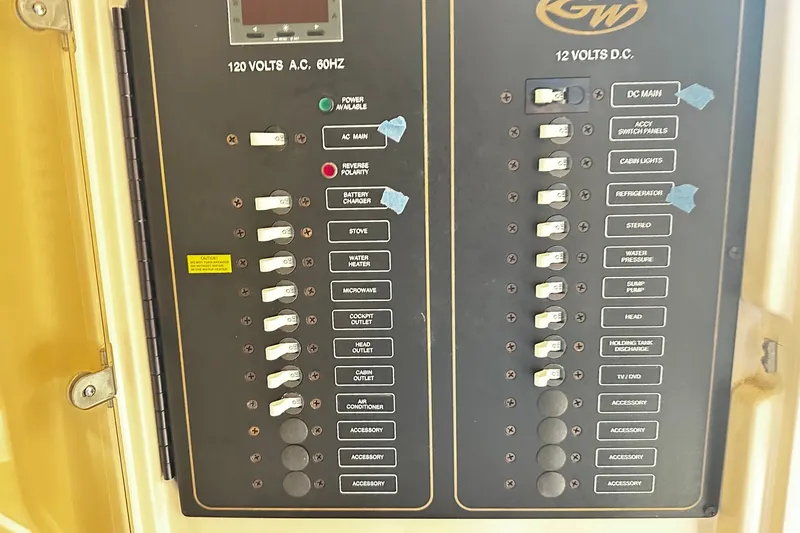 Slide: The Image of Electrical control panel on a 2007 Grady-White Express 305 boat, featuring AC and DC switches. - 21