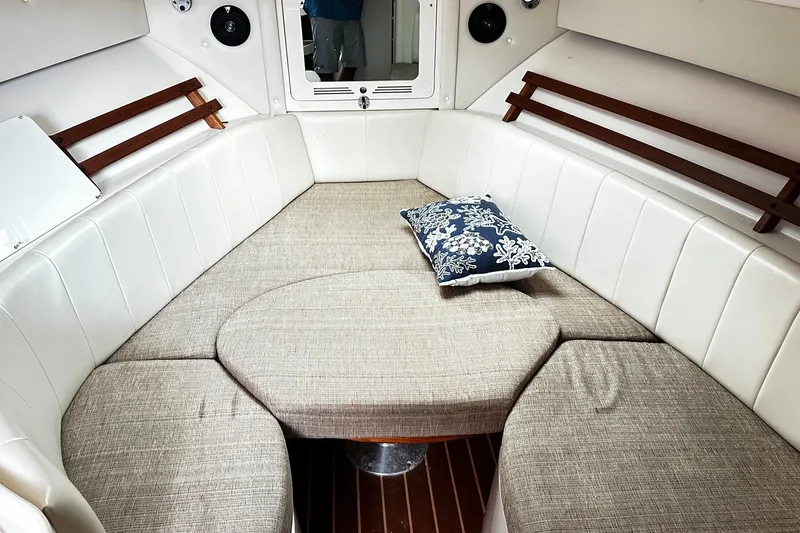 Slide: The Image of 2007 Grady-White Express 305 cabin interior with cushioned seating and decorative pillow. - 16