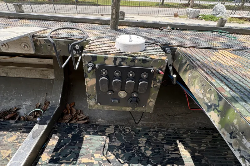 Slide: The Image of Control panel of a 2015 Gator Trax 16x44 boat with camouflage design. - 19