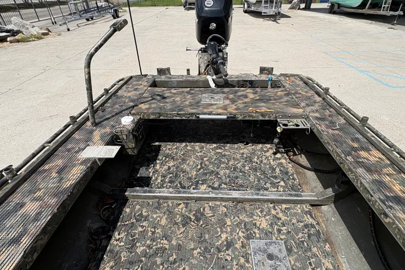 Slide: The Image of 2015 Gator Trax 16x44 boat with camouflage interior and outboard motor. - 18