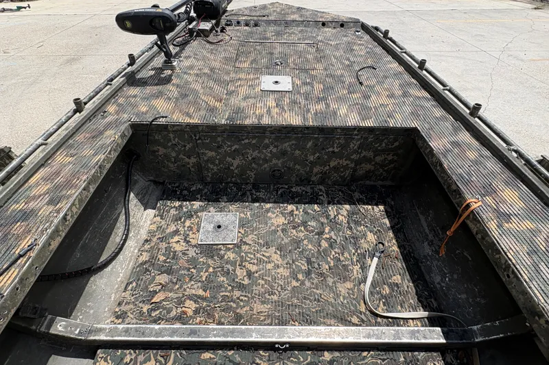 Slide: The Image of 2015 Gator Trax 16x44 boat interior with camouflage design and trolling motor. - 17