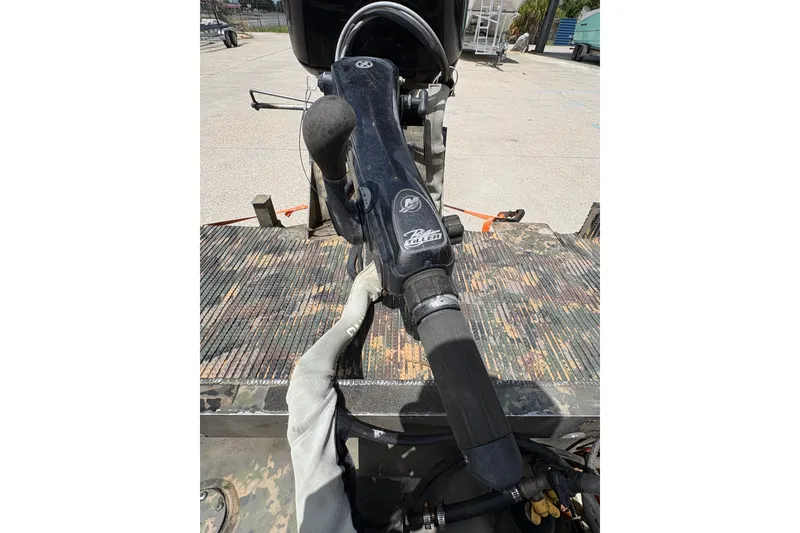 Slide: The Image of Close-up of a 2015 Gator Trax 16x44 boat motor handle on a textured surface. - 20