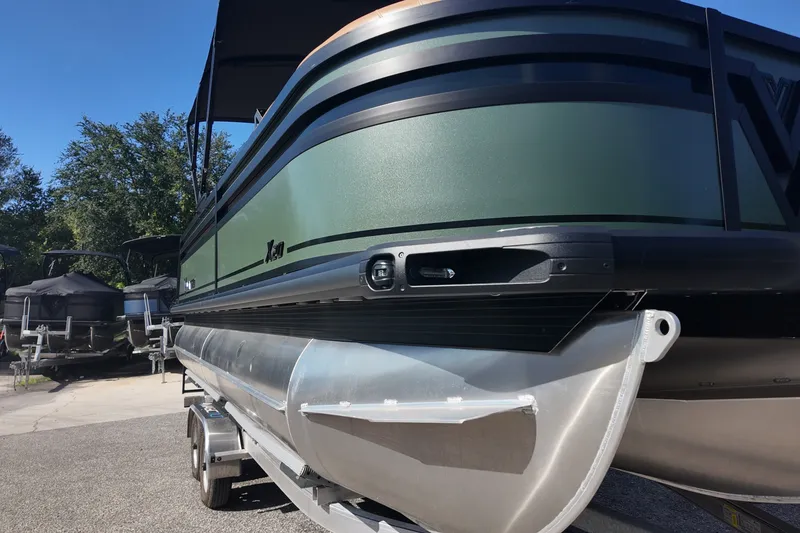 Slide: The Image of 2027 Viaggio x20u pontoon boat on trailer, featuring sleek green and black design. - 14