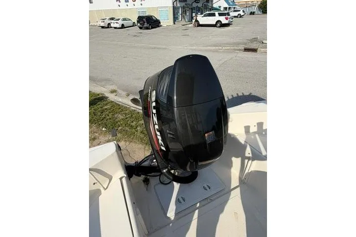 Slide: The Image of KenCraft Challenger 206 boat with Suzuki outboard motor, parked in a lot, year 2000 model. - 7