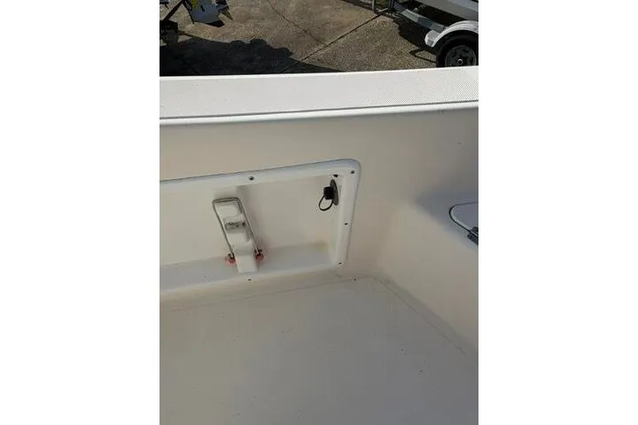 Slide: The Image of KenCraft Challenger 206 boat interior, 2000 model, featuring a clean, white deck and storage compartment. - 14