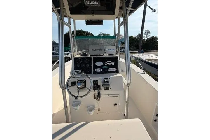 Slide: The Image of Center console of a 2000 KenCraft Challenger 206 boat with steering wheel and controls. - 8