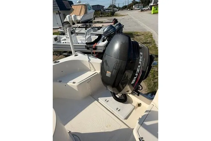 Slide: The Image of KenCraft Challenger 206 boat, 2000 model, featuring a Suzuki outboard motor, docked outdoors. - 12