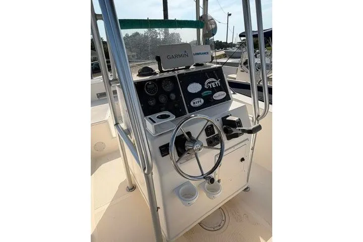 Slide: The Image of Center console of a 2000 KenCraft Challenger 206 boat with steering wheel and navigation equipment. - 10