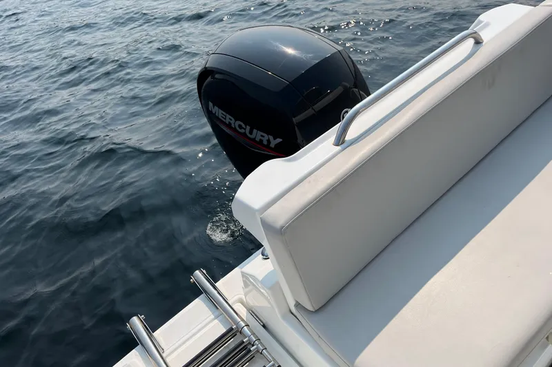 Slide: The Image of 2023 Beneteau Antares 7 with Mercury outboard engine on calm water. - 14