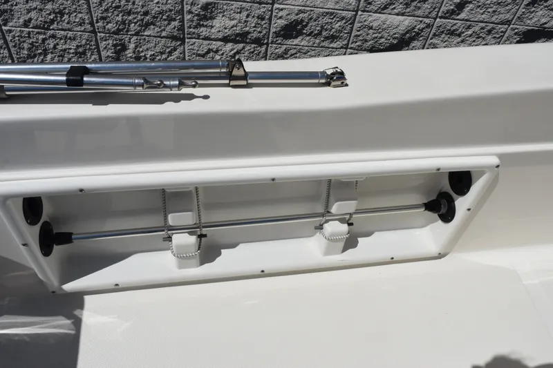 Slide: The Image of 2021 NauticStar 211 Hybrid boat rod holder and storage compartment. - 12
