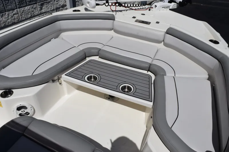 Slide: The Image of 2021 NauticStar 211 Hybrid boat interior with cushioned seating and cup holders. - 9