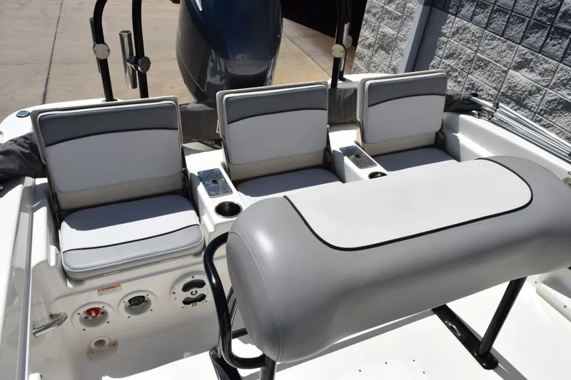Slide: The Image of 2021 NauticStar 211 Hybrid boat interior with cushioned seating and control panel. - 8