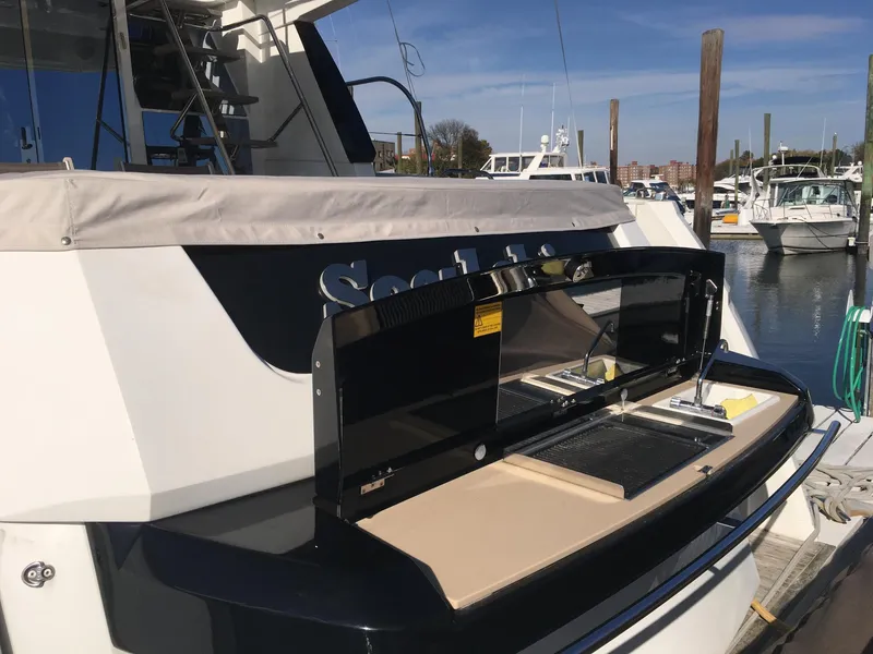 Slide: The Image of 2017 Beneteau Monte Carlo MC6 yacht with outdoor kitchen at marina. - 2