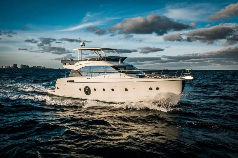 Slide: The Image of 2017 Beneteau Monte Carlo MC6 yacht cruising on open water under a partly cloudy sky. - 6
