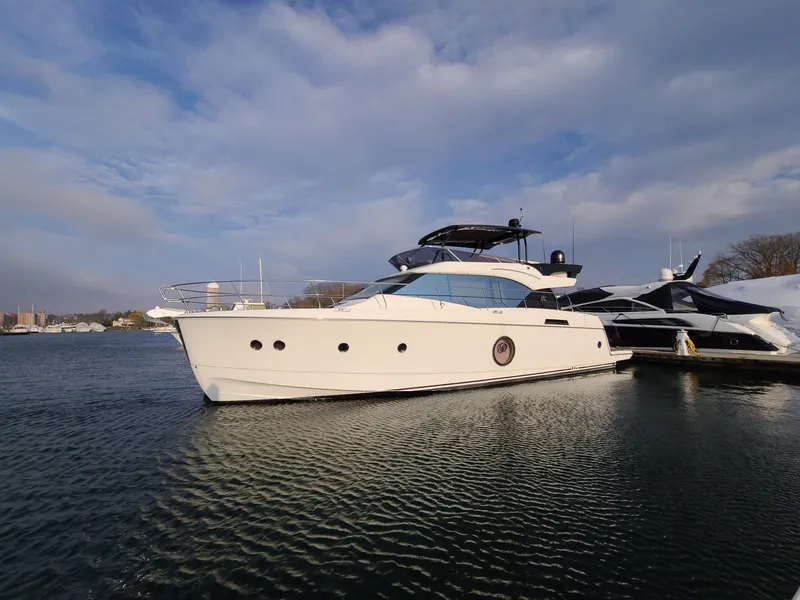 The Image of 2017 Beneteau Monte Carlo MC6 yacht docked on calm water under a cloudy sky. - 0