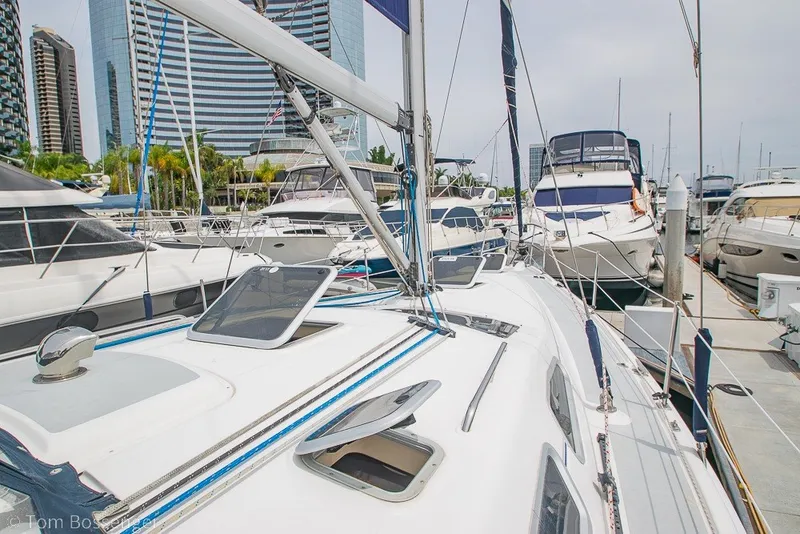 Slide: The Image of 2007 Hunter 41 Aft Cockpit sailboat docked in a marina with modern buildings nearby. - 41