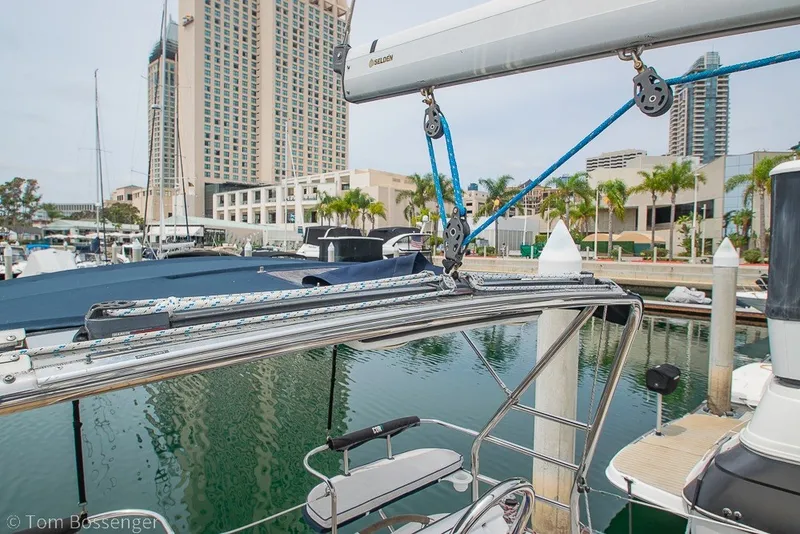 Slide: The Image of 2007 Hunter 41 Aft Cockpit sailboat docked in a marina with cityscape background. - 40