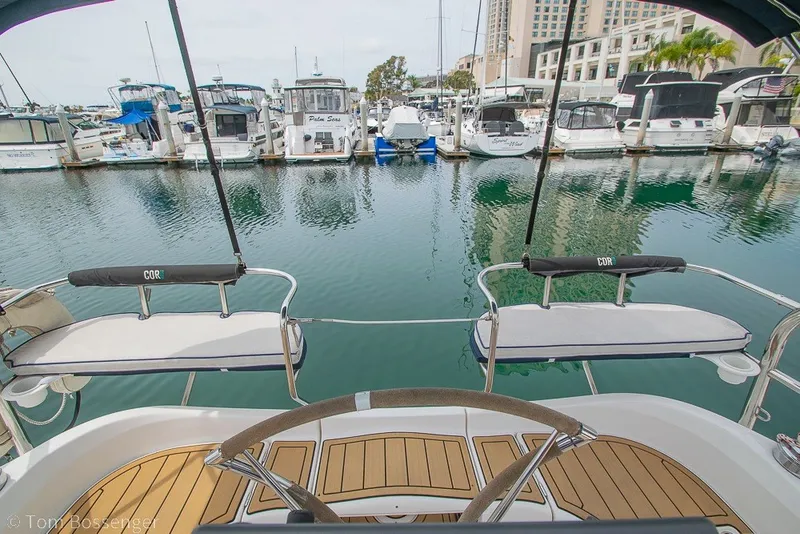 Slide: The Image of Aft cockpit view of 2007 Hunter 41 sailboat in marina, showcasing helm and seating. - 36
