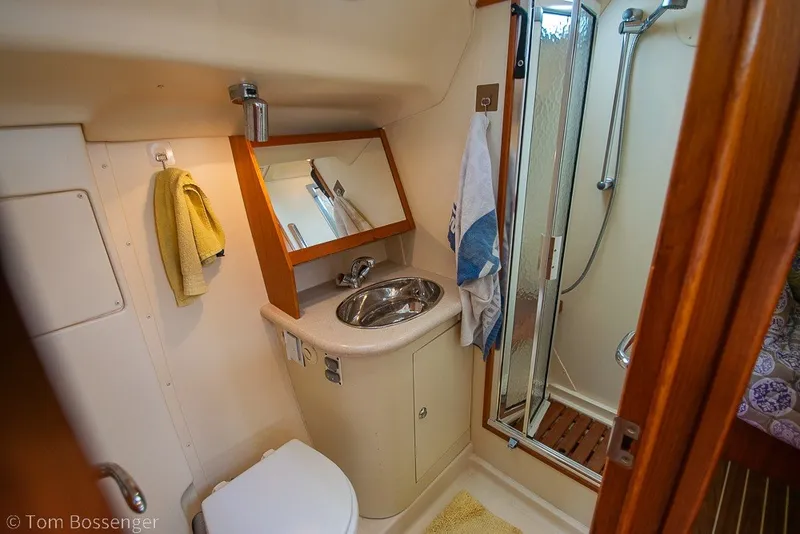 Slide: The Image of 2007 Hunter 41 Aft Cockpit bathroom with sink, mirror, and shower. - 28
