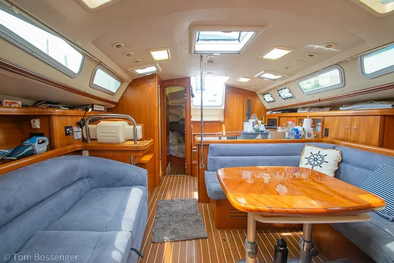 Slide: The Image of Luxurious interior of 2007 Hunter 41 Aft Cockpit sailboat with wood finishes and plush seating. - 20