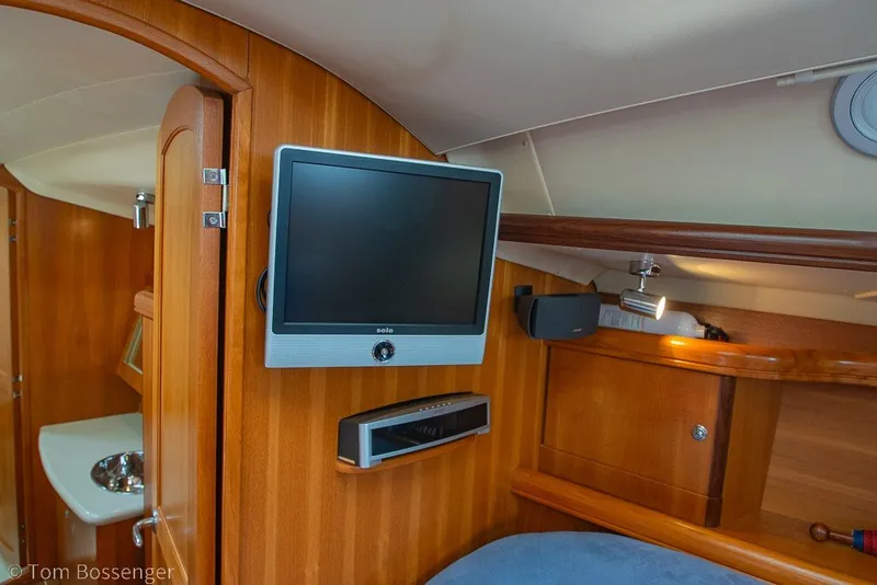 Slide: The Image of Interior of 2007 Hunter 41 Aft Cockpit yacht with TV and wooden cabinetry. - 21
