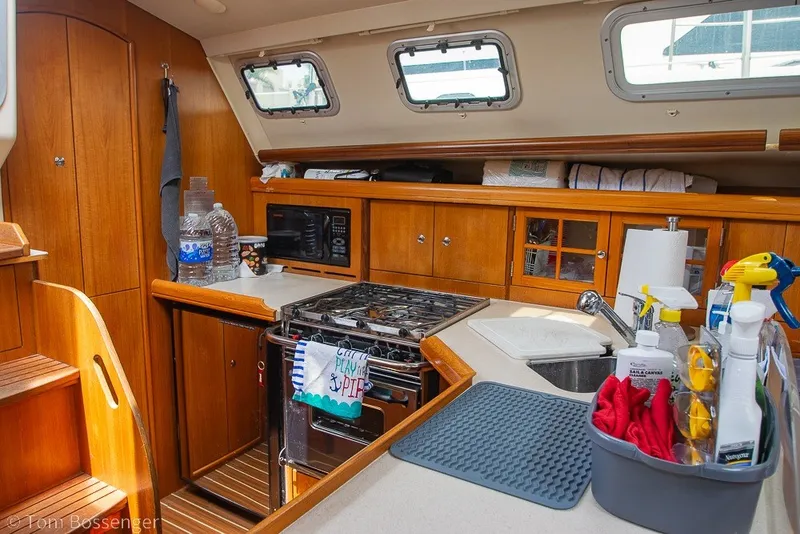 Slide: The Image of Interior of 2007 Hunter 41 Aft Cockpit yacht kitchen with wooden cabinetry and appliances. - 13