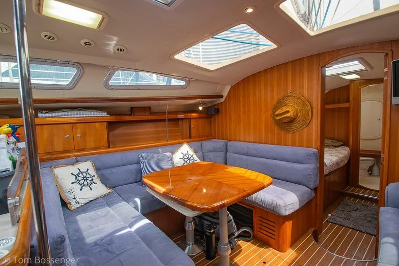 Slide: The Image of Interior of 2007 Hunter 41 Aft Cockpit yacht with cozy seating and wooden finishes. - 16