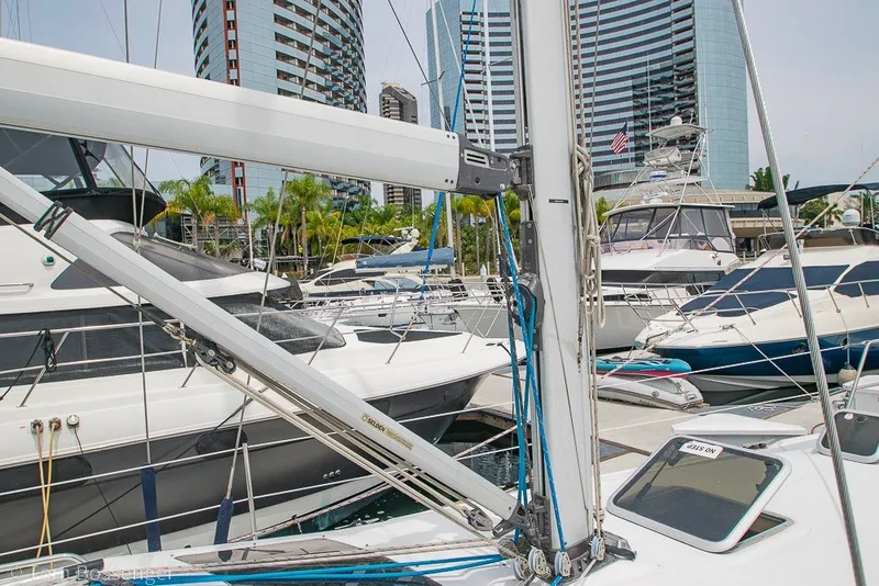 Slide: The Image of 2007 Hunter 41 Aft Cockpit sailboat docked in a marina with modern buildings. - 42