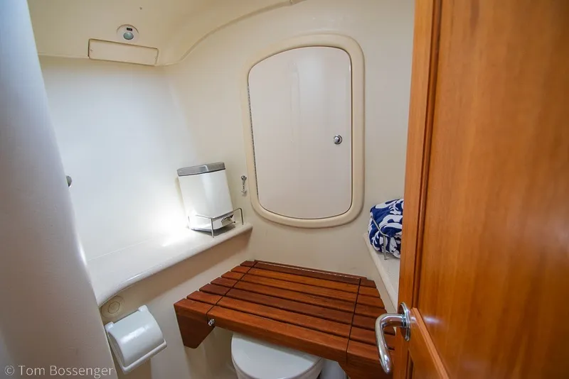 Slide: The Image of Compact bathroom in 2007 Hunter 41 Aft Cockpit yacht with wooden seat and storage. - 25
