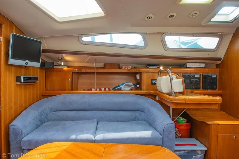 Slide: The Image of Interior of 2007 Hunter 41 Aft Cockpit yacht with blue sofa and wooden cabinetry. - 19