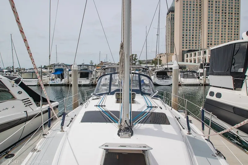 Slide: The Image of 2007 Hunter 41 Aft Cockpit sailboat docked in a marina with surrounding yachts. - 49