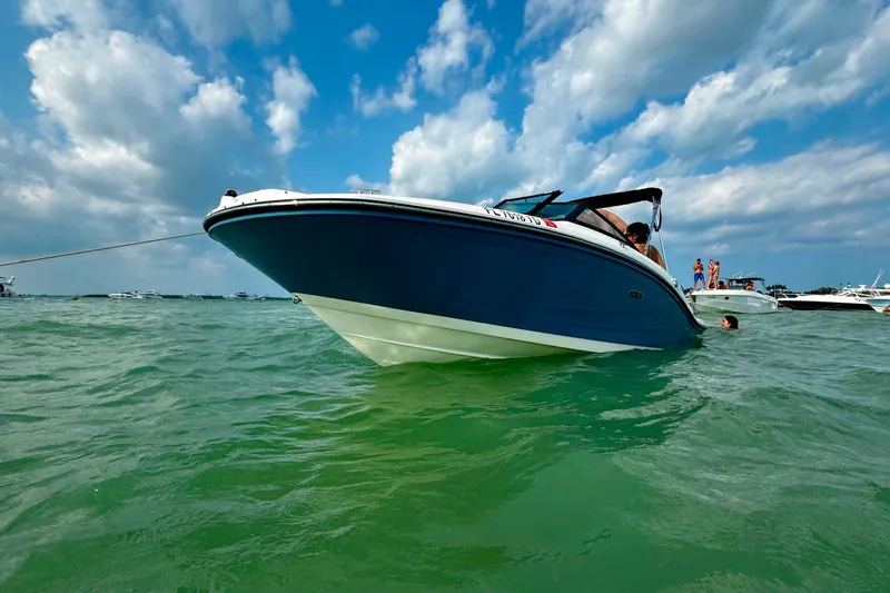 The Image of 2022 Sea Ray SPX 190 boat on water under a partly cloudy sky. - 1