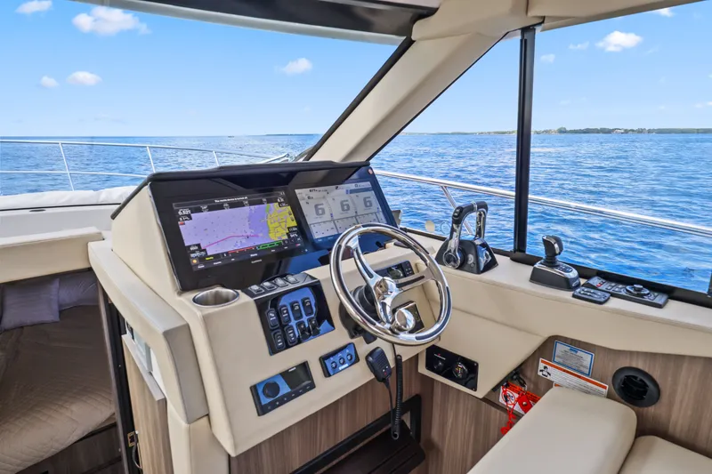 Slide: The Image of 2021 Regal 38 XO yacht helm with advanced navigation system on open water. - 27