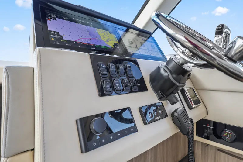 Slide: The Image of Helm of 2021 Regal 38 XO yacht with navigation controls and steering wheel. - 31