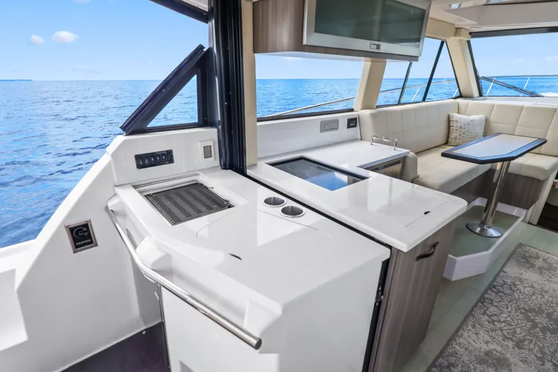 Slide: The Image of Interior of 2021 Regal 38 XO yacht with modern kitchen and seating area. - 19