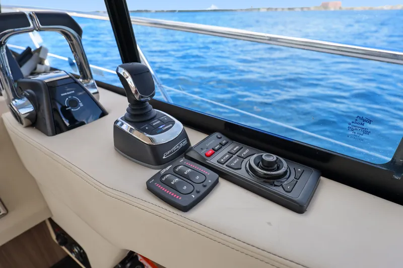 Slide: The Image of Control panel of a 2021 Regal 38 XO yacht with joystick and navigation controls. - 28