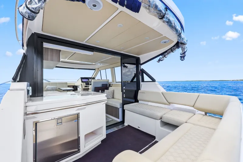 Slide: The Image of Luxurious 2021 Regal 38 XO yacht interior with spacious seating and ocean view. - 15