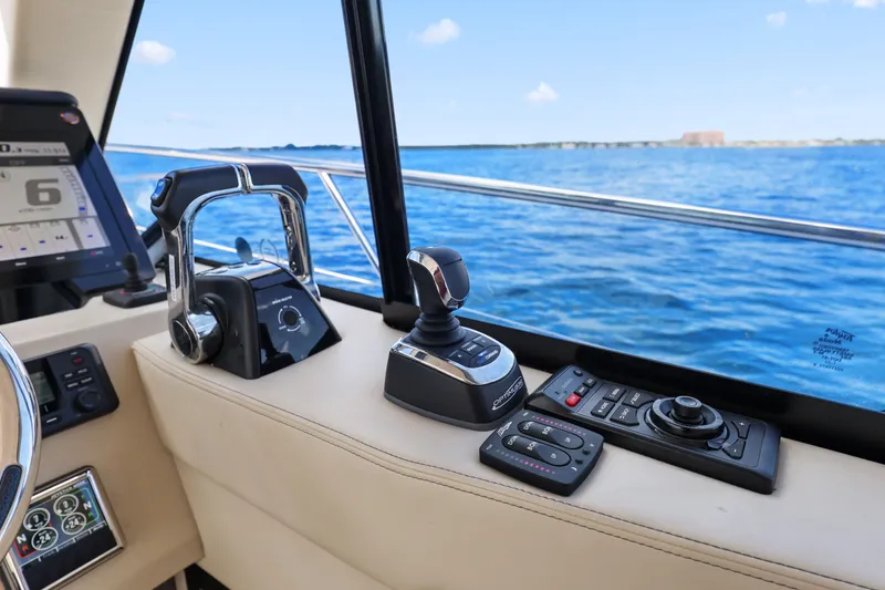 Slide: The Image of Control panel of 2021 Regal 38 XO yacht with ocean view in background. - 29