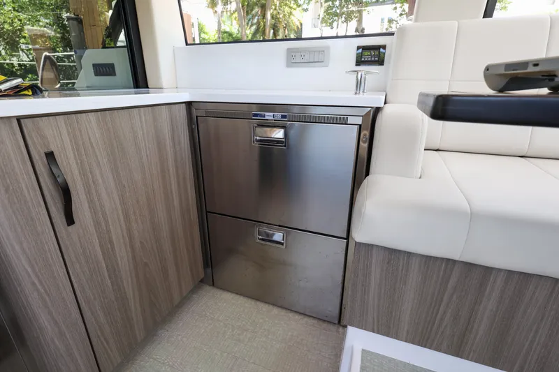 Slide: The Image of 2021 Regal 38 XO yacht interior with modern kitchen cabinetry and stainless steel appliances. - 33