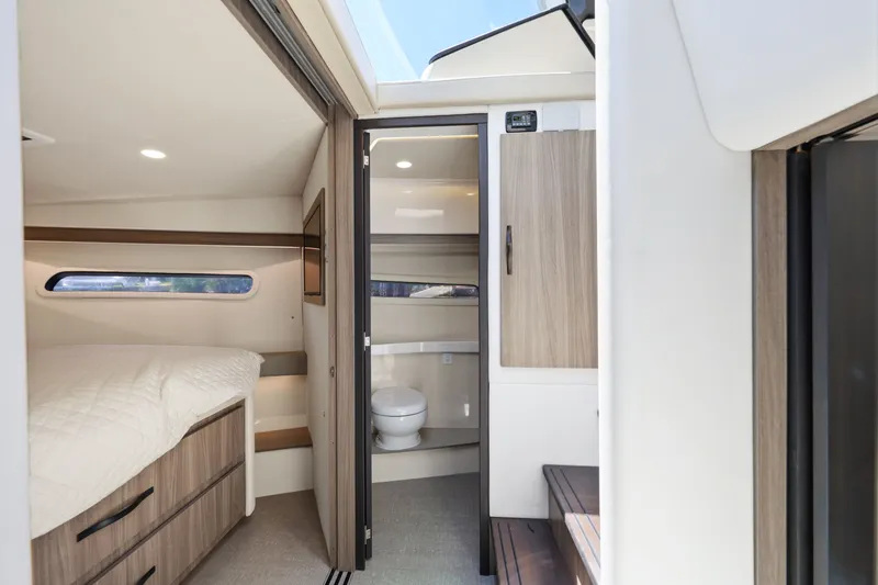Slide: The Image of Interior cabin of 2021 Regal 38 XO yacht, featuring a cozy bedroom and modern bathroom. - 36