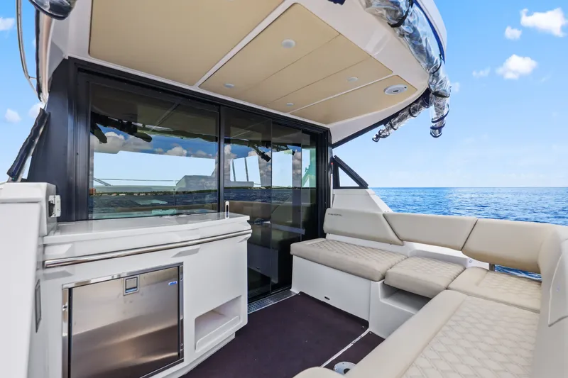 Slide: The Image of Luxurious 2021 Regal 38 XO yacht interior with ocean view and comfortable seating. - 13
