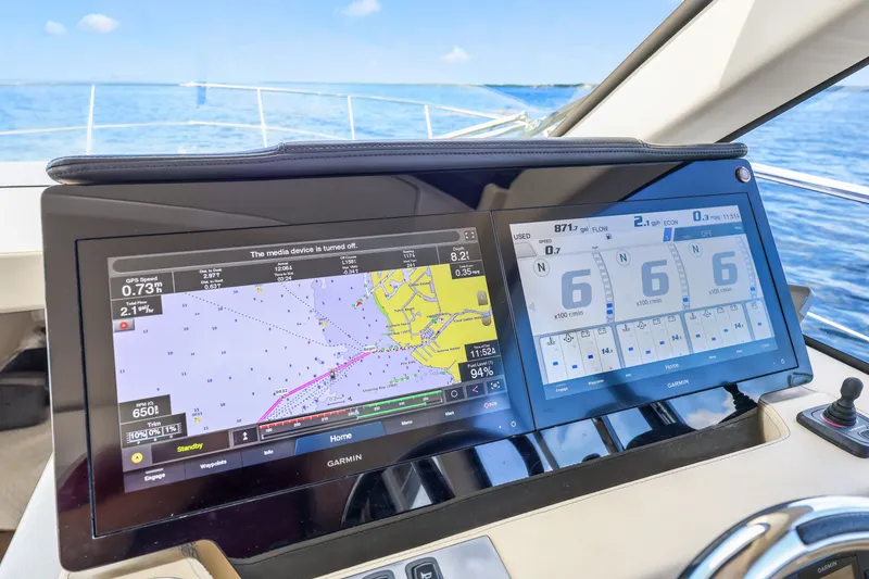 Slide: The Image of Cockpit navigation screens on a 2021 Regal 38 XO yacht, displaying GPS and engine data. - 30